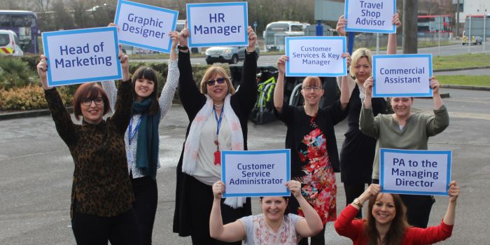 Photo of Damory, Excelsior and Tourist women staff holding up their job titles